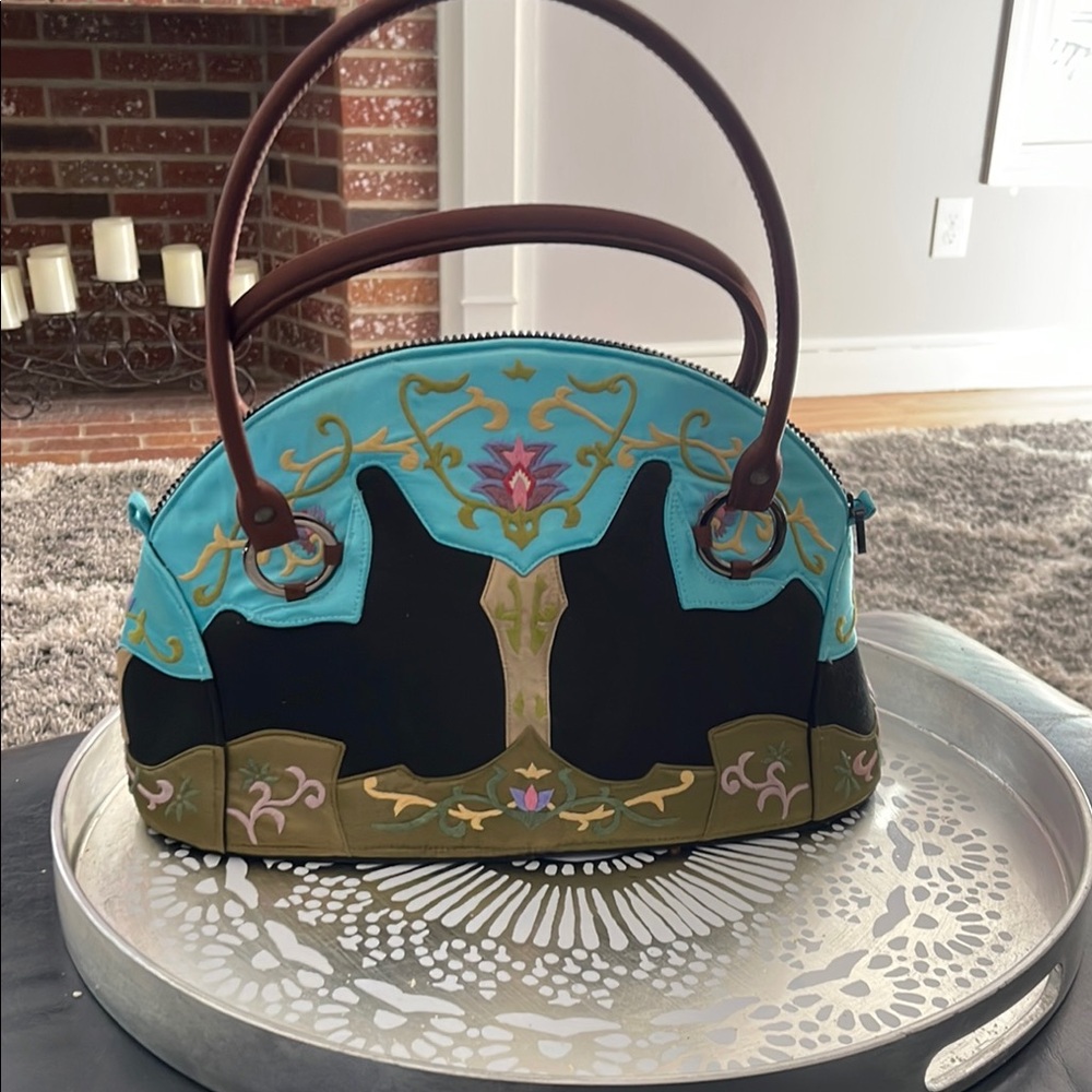 Elegant Blue and Black Shoulder Bag with Artistic Flair